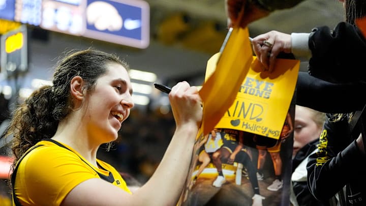 Iowa center Ava Heiden (5) signs autographs for fans after the Hawkeyes defeated the Nebraska Cornhuskers Jan. 1, 2026 at Carver-Hawkeye Arena in Iowa City, Iowa.