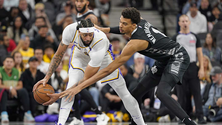 Nov 15, 2024; San Antonio, Texas, USA; Los Angeles Lakers forward Anthony Davis (3) looks to pass the ball while defended by San Antonio Spurs center Victor Wembanyama (1) during the first half during the first half at Frost Bank Center. Mandatory Credit: Scott Wachter-Imagn Images