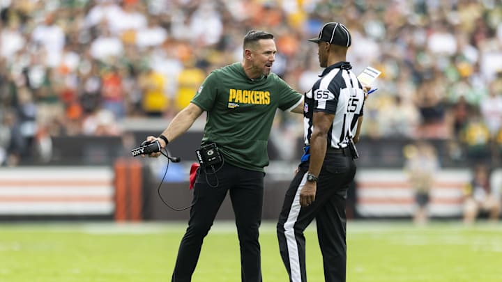 Sep 21, 2025; Cleveland, Ohio, USA; Green Bay Packers head coach Matt LaFleur argues a call with line judge Walt Coleman IV (65) during the fourth quarter at Huntington Bank Field. Mandatory Credit: Scott Galvin-Imagn Images