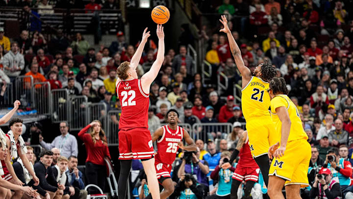 Wisconsin forward Austin Rapp (22) shoots a 3-pointer against Michigan forward Morez Johnson Jr. (21) during the second half of Big Ten Tournament semifinal at United Center in Chicago on Saturday, March 14, 2026.