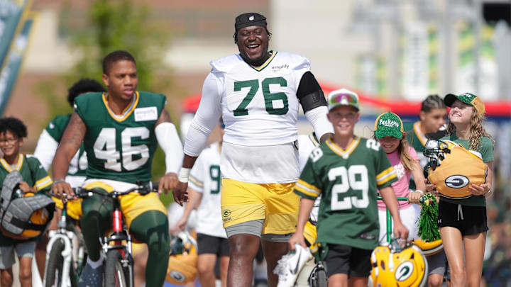 Green Bay Packers tackle Kadeem Telfort (76) laughs with young fans while walking along the Dream Drive before practice on Aug. 7, 2025, in Green Bay, Wis. Green Bay Packers tackle Kadeem Telfort (76) laughs with young fans while walking along the Dream Drive before practice on Aug. 7, 2025, in Green Bay, Wis.