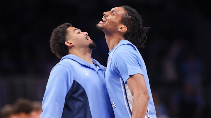 Dec 20, 2025; Atlanta, Georgia, USA; North Carolina Tar Heels guard Elijah Davis (6) and forward Jarin Stevenson (15) react during a timeout against the Ohio State Buckeyes in the second half at State Farm Arena. Mandatory Credit: Brett Davis-Imagn Images
