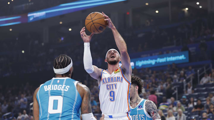 Oct 9, 2025; Oklahoma City, Oklahoma, USA; Oklahoma City Thunder guard Alex Caruso (9) goes up for a basket against Charlotte Hornets forward Miles Bridges (0) during the 1st quarter of a game between the Charlotte Hornets and the Oklahoma City Thunder at Paycom Center. Mandatory Credit: Alonzo Adams-Imagn Images Oct 9, 2025; Oklahoma City, Oklahoma, USA; Oklahoma City Thunder guard Alex Caruso (9) goes up for a basket against Charlotte Hornets forward Miles Bridges (0) during the 1st quarter of a game between the Charlotte Hornets and the Oklahoma City Thunder at Paycom Center. Mandatory Credit: Alonzo Adams-Imagn Images