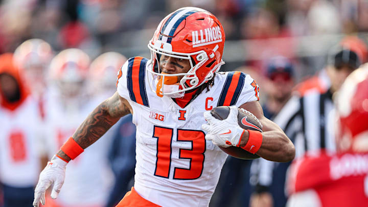 Nov 23, 2024; Piscataway, New Jersey, USA; Illinois Fighting Illini wide receiver Pat Bryant (13) gains yards after catch during the second half against the Rutgers Scarlet Knights at SHI Stadium. Mandatory Credit: Vincent Carchietta-Imagn Images