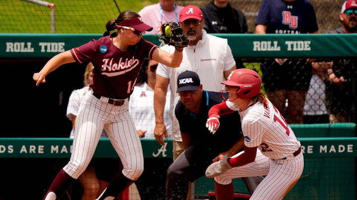 May 17, 2025; Tuscaloosa, AL, USA; Virginia Tech third baseman Jordan Lynch leaps to catch a ball from the outfield as Alabama base runner Audrey Vandagriff slides safely into third at Rhoads Stadium. Alabama defeated Virginia Tech 4-3 to advance to the final.