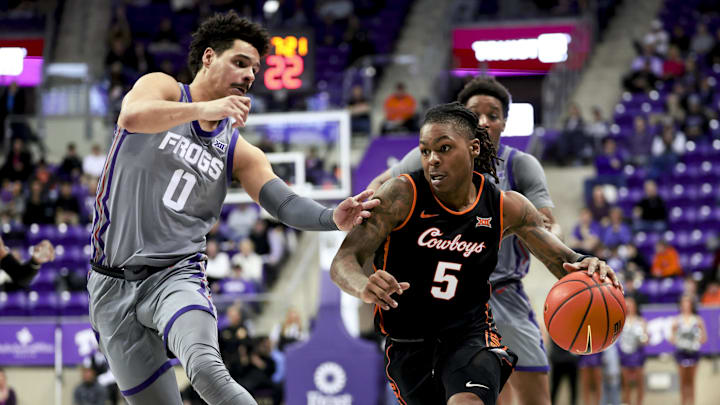 Feb 12, 2025; Fort Worth, Texas, USA; Oklahoma State Cowboys guard Khalil Brantley (5) dribbles as TCU Horned Frogs guard Brendan Wenzel (0) defends during the second half at Ed and Rae Schollmaier Arena. Mandatory Credit: Kevin Jairaj-Imagn Images