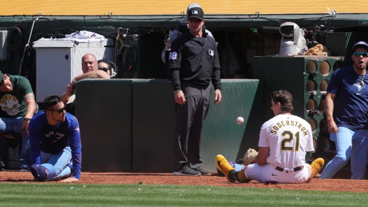 Toronto Blue Jays starting pitcher Yusei Kikuchi (left on ground) and Oakland Athletics first baseman Tyler Soderstrom (21) look at each other after colliding during a foul fly ball in the tenth inning at Oakland-Alameda County Coliseum on June 9. Toronto Blue Jays starting pitcher Yusei Kikuchi (left on ground) and Oakland Athletics first baseman Tyler Soderstrom (21) look at each other after colliding during a foul fly ball in the tenth inning at Oakland-Alameda County Coliseum on June 9.