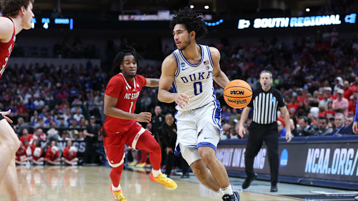 Mar 31, 2024; Dallas, TX, USA; Duke Blue Devils guard Jared McCain (0) controls the ball against North Carolina State Wolfpack guard Jayden Taylor (1) in the second half in the finals of the South Regional of the 2024 NCAA Tournament at American Airline Center. Mandatory Credit: Tim Heitman-USA TODAY Sports