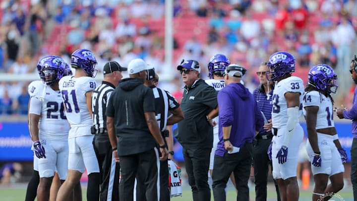 Members of the TCU football team huddle around head coach Sonny Dykes during the SMU game. 
