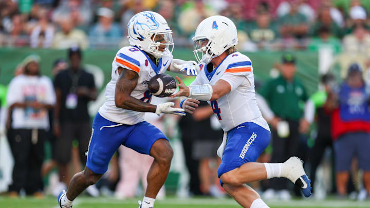 Aug 28, 2025; Tampa, Florida, USA; Boise State Broncos quarterback Maddux Madsen (4) hands off to Boise State Broncos running back Malik Sharrod (8) against the South Florida Bulls in the second quarter at Raymond James Stadium. M Aug 28, 2025; Tampa, Florida, USA; Boise State Broncos quarterback Maddux Madsen (4) hands off to Boise State Broncos running back Malik Sharrod (8) against the South Florida Bulls in the second quarter at Raymond James Stadium. M