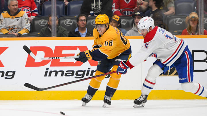 Apr 6, 2025; Nashville, Tennessee, USA;  Nashville Predators left wing Zachary L'Heureux (68) blocks the shot of Montreal Canadiens center Nick Suzuki (14) during the third period at Bridgestone Arena. Mandatory Credit: Steve Roberts-Imagn Images