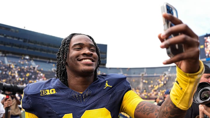 Michigan quarterback Bryce Underwood (19) records a video to celebrate 63-3 win over Central Michigan as he exits the field at Michigan Stadium in Ann Arbor on Saturday, Sept. 13, 2025.