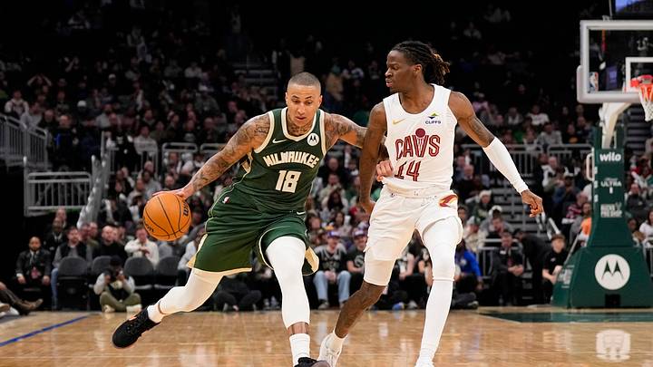 Feb 25, 2026; Milwaukee, Wisconsin, USA;  Milwaukee Bucks forward Kyle Kuzma (18) drives up court against Cleveland Cavaliers guard Keon Ellis (14) during the third quarter at Fiserv Forum. Mandatory Credit: Jeff Hanisch-Imagn Images