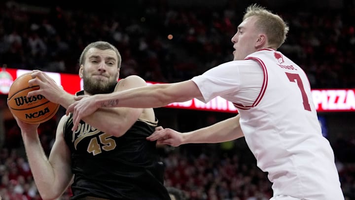 Purdue center Oscar Cluff (45) beats Wisconsin guard Andrew Rohde (7) to a rebound during the second half of their game Saturday, January 3, 2026 at the Kohl Center in Madison, Wisconsin. Purdue beat Wisconsin 89-73.