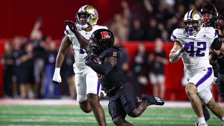 Sep 27, 2024; Piscataway, New Jersey, USA; Rutgers Scarlet Knights running back Kyle Monangai (5) carries the ball as Washington Huskies linebacker Carson Bruener (42) pursues during the first half at SHI Stadium. Mandatory Credit: Vincent Carchietta-Imagn Images