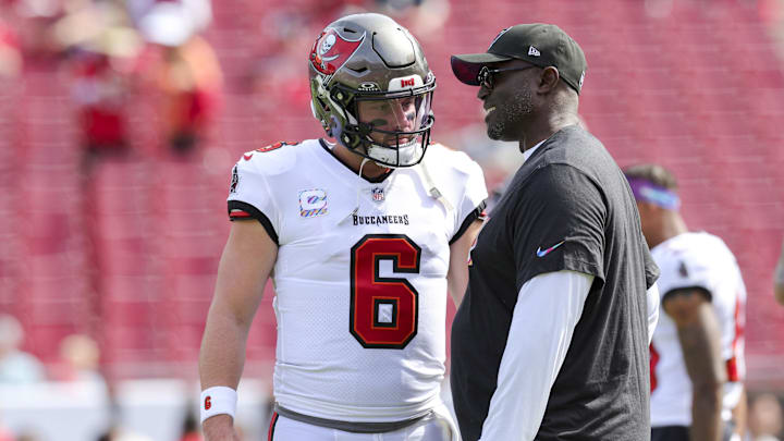 Tampa Bay Buccaneers quarterback Baker Mayfield speaks to head coach Todd Bowles before a game against the Atlanta Falcons.