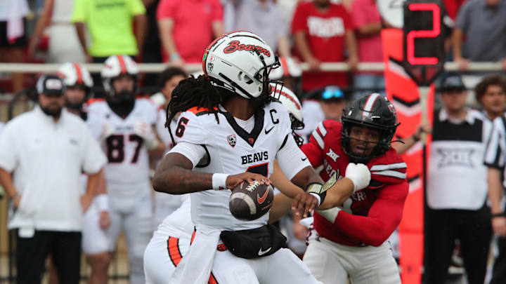 Sep 13, 2025; Lubbock, Texas, USA;   Oregon State Beavers quarterback Maalik Murphy (6) is pressured by Texas Tech Red Raiders defensive back Romello Height (9) in the first half at Jones AT&T Stadium. Mandatory Credit: Michael C. Johnson-Imagn Images