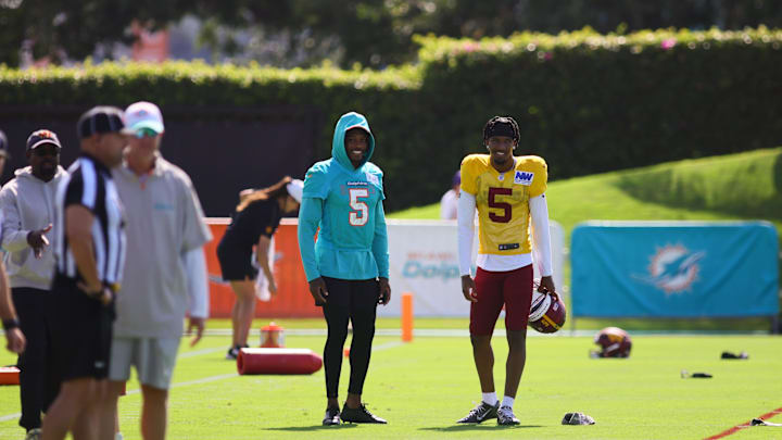 Miami Dolphins cornerback Jalen Ramsey (5) and Washington Commanders quarterback Jayden Daniels (5) talk on the field during joint practice at Baptist Health Training Complex.