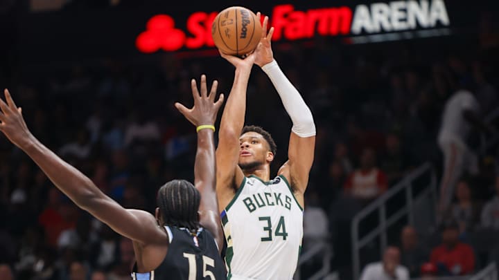 Mar 30, 2024; Atlanta, Georgia, USA; Milwaukee Bucks forward Giannis Antetokounmpo (34) shoots over Atlanta Hawks center Clint Capela (15) in the second quarter at State Farm Arena. Mandatory Credit: Brett Davis-Imagn Images