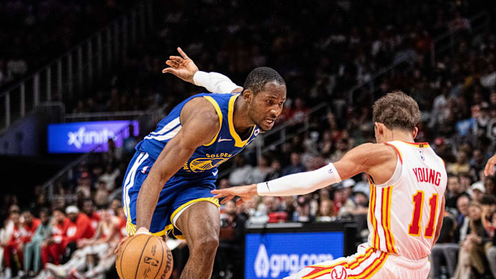 Feb 3, 2024; Atlanta, Georgia, USA; Golden State Warriors forward Jonathan Kuminga (00) drives the ball against Atlanta Hawks guard Trae Young (11) during the third quarter at State Farm Arena. Mandatory Credit: Jordan Godfree-Imagn Images