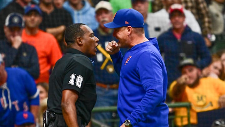 Sep 27, 2024; Milwaukee, Wisconsin, USA;  New York Mets manager Carlos Mendoza argues with home plate umpire Ramon De Jesus in the fourth inning against the Milwaukee Brewers at American Family Field. Mandatory Credit: Benny Sieu-Imagn Images