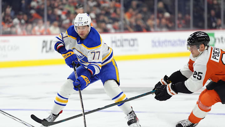 Mar 29, 2025; Philadelphia, Pennsylvania, USA; Buffalo Sabres right wing JJ Peterka (77) controls the puck against Philadelphia Flyers center Ryan Poehling (25) in the third period at Wells Fargo Center. Mandatory Credit: Kyle Ross-Imagn Images