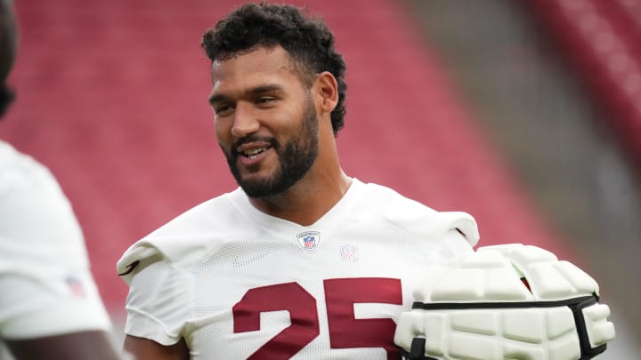 Arizona Cardinals linebacker Zaven Collins (25) chats with his teammates during training camp at State Farm Stadium in Glendale on July 25, 2024. Arizona Cardinals linebacker Zaven Collins (25) chats with his teammates during training camp at State Farm Stadium in Glendale on July 25, 2024.