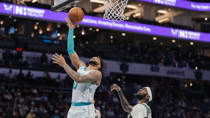 Feb 5, 2025; Charlotte, North Carolina, USA; Charlotte Hornets forward Miles Bridges (0) goes to the basket against Milwaukee Bucks forward Bobby Portis (9) during the second half at Spectrum Center. Mandatory Credit: Jim Dedmon-Imagn Images