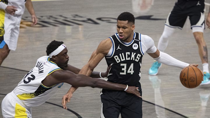 Apr 19, 2025; Indianapolis, Indiana, USA;  Milwaukee Bucks forward Giannis Antetokounmpo (34) dribbles the ball while Indiana Pacers forward Pascal Siakam (43) defends in the first half at Gainbridge Fieldhouse. Mandatory Credit: Trevor Ruszkowski-Imagn Images