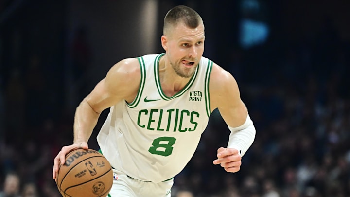 Mar 5, 2024; Cleveland, Ohio, USA;  Boston Celtics center Kristaps Porzingis (8) brings the ball up vs. the Cleveland Cavaliers.