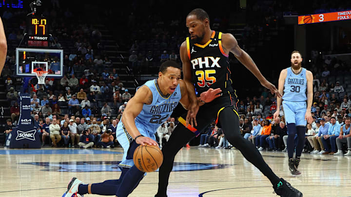 Mar 10, 2025; Memphis, Tennessee, USA; Memphis Grizzlies guard Desmond Bane (22) drives to the basket as Phoenix Suns forward Kevin Durant (35) defends during the first quarter at FedExForum. Mandatory Credit: Petre Thomas-Imagn Images