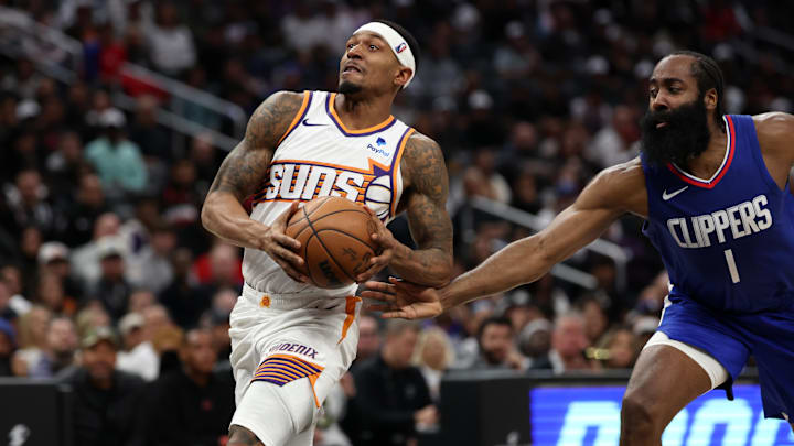 Jan 8, 2024; Los Angeles, California, USA;  Phoenix Suns guard Bradley Beal (3) drives to the basket past Los Angeles Clippers guard James Harden (1) during the fourth quarter at Crypto.com Arena. Mandatory Credit: Kiyoshi Mio-Imagn Images