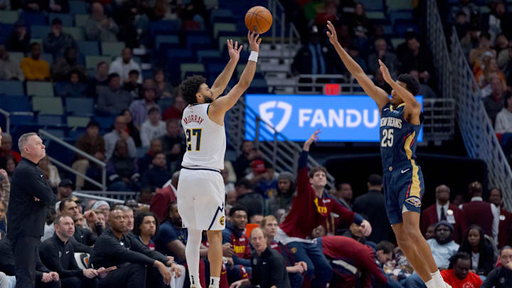 Dec 22, 2024; New Orleans, Louisiana, USA; Denver Nuggets guard Jamal Murray (27) shoots a three point basket against New Orleans Pelicans guard Trey Murphy III (25) during the first half at Smoothie King Center. Mandatory Credit: Matthew Hinton-Imagn Images