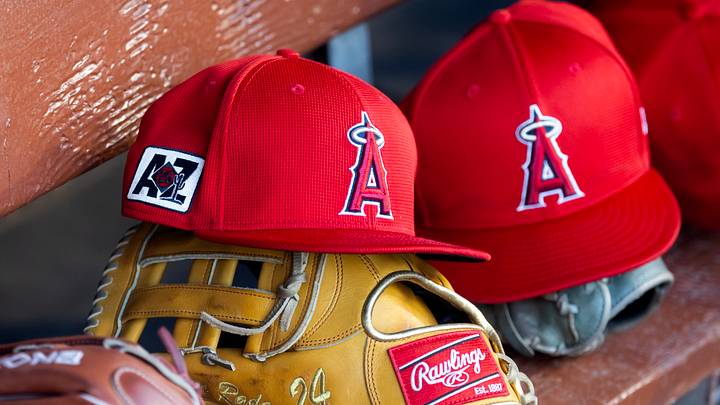 Feb 28, 2025; Phoenix, Arizona, USA; Detailed view of the Los Angeles Angels logo on a hat in the dugout during a spring training game at Camelback Ranch-Glendale. Mandatory Credit: Mark J. Rebilas-Imagn Images