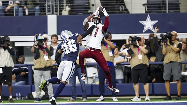 Jan 5, 2025; Arlington, Texas, USA;  Washington Commanders wide receiver Terry McLaurin (17) makes the game-winning touchdown catch over Dallas Cowboys cornerback DaRon Bland (26) during the fourth quarter at AT&T Stadium. Mandatory Credit: Kevin Jairaj-Imagn Images