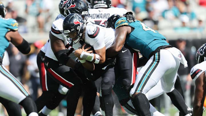 Sep 21, 2025; Jacksonville, Florida, USA; Houston Texans quarterback C.J. Stroud (7) gets sacked by Jacksonville Jaguars defensive end Josh Hines-Allen (41) in the third quarter at EverBank Stadium. Mandatory Credit: Morgan Tencza-Imagn Images