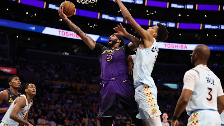 Jan 13, 2025; Los Angeles, California, USA;  Los Angeles Lakers forward Anthony Davis (3) goes to the basket against San Antonio Spurs center Victor Wembanyama (1) during the first quarter at Crypto.com Arena. Mandatory Credit: Kiyoshi Mio-Imagn Images