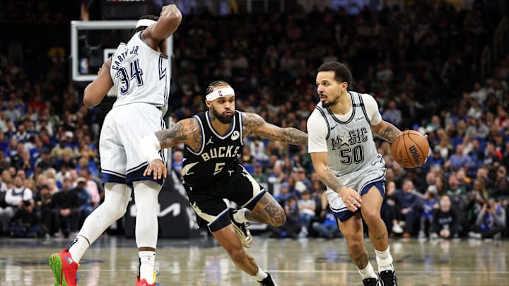 Jan 10, 2025; Orlando, Florida, USA; Orlando Magic guard Cole Anthony (50) moves the ball past Milwaukee Bucks guard Gary Trent Jr. (5) in the fourth quarter at Kia Center. Mandatory Credit: Nathan Ray Seebeck-Imagn Images