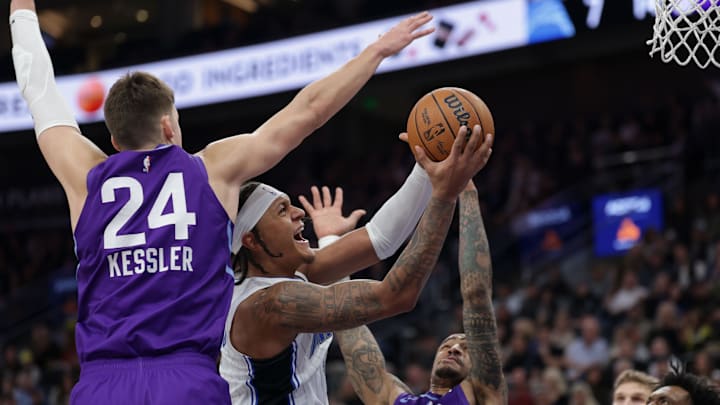 Orlando Magic forward Paolo Banchero (5) drives to the basket against Utah Jazz center Walker Kessler (24) and forward John Collins (20) during the first quarter at Delta Center.