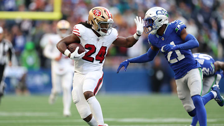 San Francisco 49ers running back Jordan Mason (L) and Seattle Seahawks cornerback Devon Witherspoon (R)