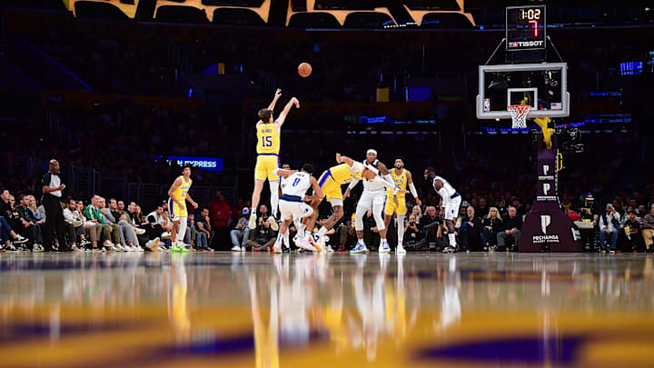 Nov 22, 2023; Los Angeles, California, USA; Los Angeles Lakers guard Austin Reaves (15) shoots against the Dallas Mavericks during the first half at Crypto.com Arena. Mandatory Credit: Gary A. Vasquez-USA TODAY Sports