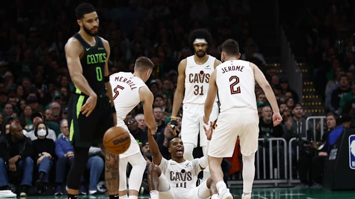 Feb 28, 2025; Boston, Massachusetts, USA; Cleveland Cavaliers guard Darius Garland (10) smiles as he is helped up by teammates after Boston Celtics forward Jayson Tatum (0) was called for an offensive foul during the second half at TD Garden. Mandatory Credit: Winslow Townson-Imagn Images