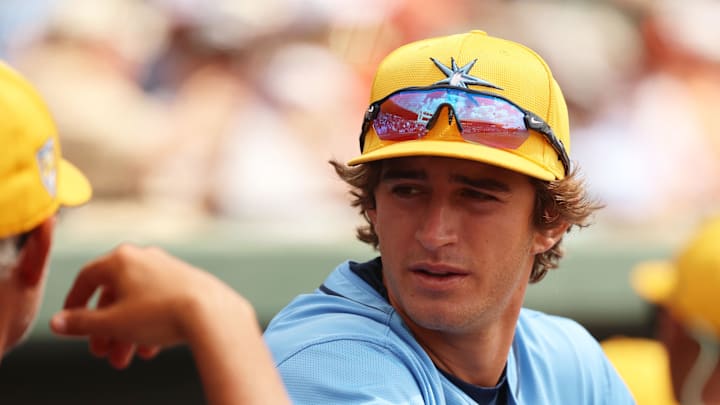 Tampa Bay Rays infielder Carson Williams (80) talks with manager Kevin Cash (16) before the game against the Baltimore Orioles at Ed Smith Stadium in 2024.