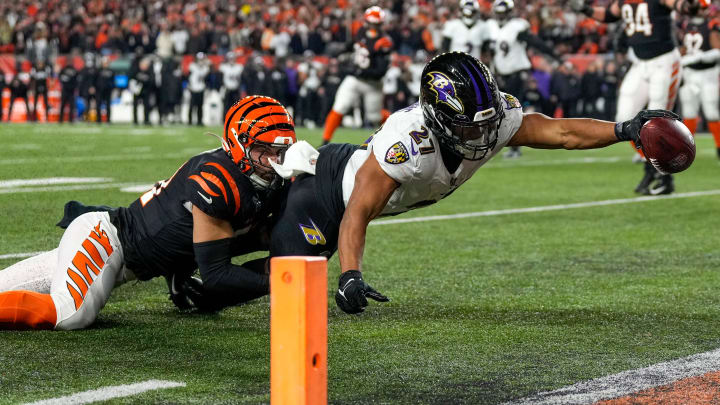 Baltimore Ravens running back J.K. Dobbins (27) breaks a tackle from Cincinnati Bengals linebacker Baltimore Ravens running back J.K. Dobbins (27) breaks a tackle from Cincinnati Bengals linebacker