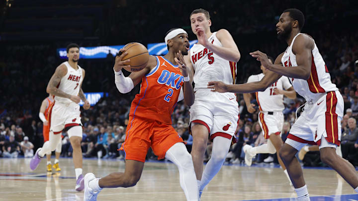 Jan 11, 2026; Oklahoma City, Oklahoma, USA; Oklahoma City Thunder guard Shai Gilgeous-Alexander (2) drives to the basket around Miami Heat forward Nikola Jović (5) during the second half at Paycom Center. Mandatory Credit: Alonzo Adams-Imagn Images