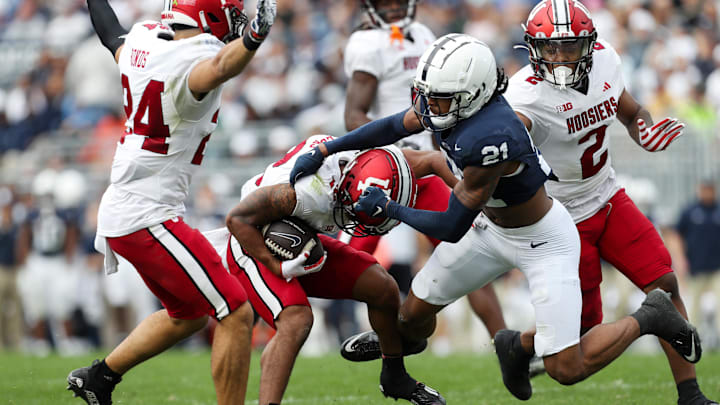 Oct 28, 2023; University Park, Pennsylvania, USA; Penn State Nittany Lions safety Kevin Winston Jr. (21) attempts to tackle Indiana Hoosiers running back Jaylin Lucas (12) during the third quarter at Beaver Stadium. Penn State defeated Indiana 33-24. Mandatory Credit: Matthew O'Haren-Imagn Images