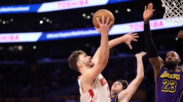 Mar 31, 2025; Los Angeles, California, USA;  Houston Rockets center Alperen Sengun (28) shoots the ball as Los Angeles Lakers forward LeBron James (23) going to block a shot during the fourth quarter at Crypto.com Arena. Mandatory Credit: Kiyoshi Mio-Imagn Images