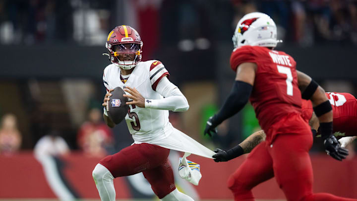 Sep 29, 2024; Glendale, Arizona, USA; Washington Commanders quarterback Jayden Daniels (5) against the Arizona Cardinals at State Farm Stadium. Mandatory Credit: Mark J. Rebilas-Imagn Images