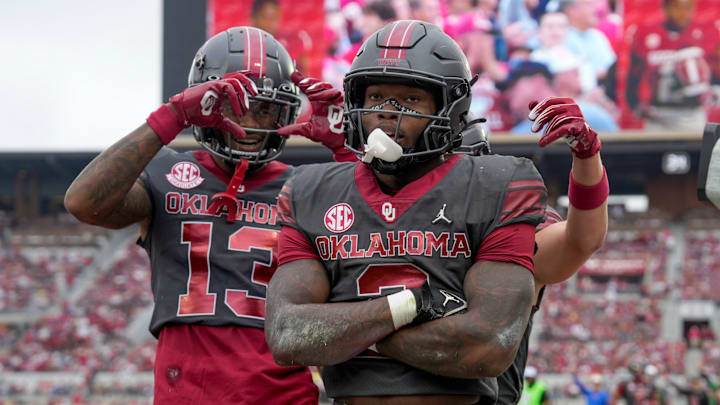 Oklahoma Sooners running back Jovantae Barnes (2) celebrates with Oklahoma Sooners wide receiver J.J. Hester (13).
