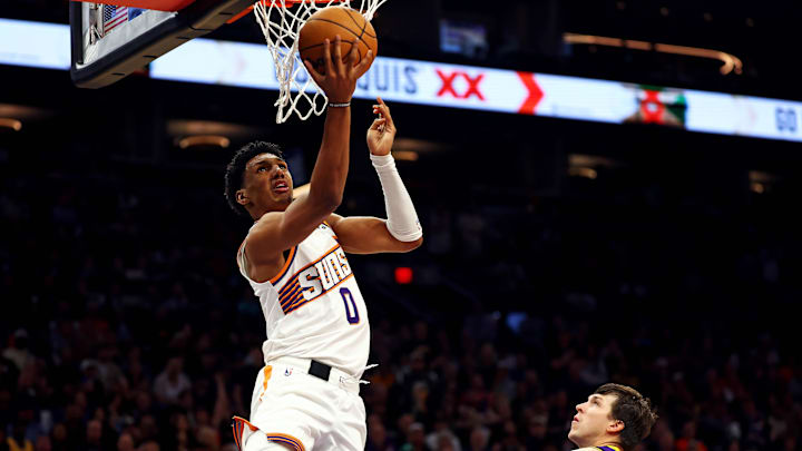 Oct 28, 2024; Phoenix, Arizona, USA; Phoenix Suns forward Ryan Dunn (0) shoots the ball against Los Angeles Lakers guard Austin Reaves (15) during the second half at Footprint Center. Mandatory Credit: Mark J. Rebilas-Imagn Images